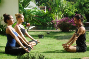 Featured image of top 30 yoga retreats for November 2017 with two female yogis in lotus pose led by male yoga teacher and healer at the 3-day Detoxify and Recharge Yoga Retreat in Angkor, Cambodia