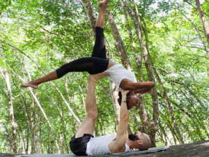 Featured image for 5 Days Meditation and Yoga Retreat in Kalutara, Sri Lanka with 2 yogis doing acro yoga together in middle of nature setting