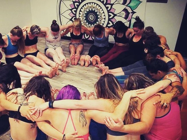 Yoga teacher training graduates in meditation after class in Carlsbad, California